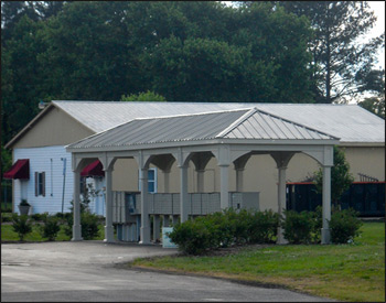 Custom 10 x 40 Vinyl Ramada shown with Elegant Ivory Vinyl, No Deck, 6" Post Trim, 6x6 Posts, 6" Taller Posts, No Cupola, Clay Metal Roof, and Stainless Steel Hardware.