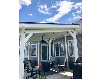 12 x 14 White Vinyl Pergola Pavilion shown with 6x6 Vinyl Sleeves over Posts, 36" Post Trim, Double 2"x8" Headers, Charcoal Metal Roof, 2/12 Pitch Roof, and Vinyl Ceiling.