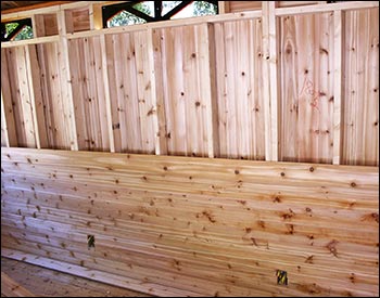 Unfinished Interior of Cabana shown with exposed studs (top) and cedar wall boards (bottom)