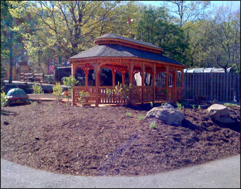 12x24 Red Cedar Oval Double Roof Gazebo shown with Weathered Wood Asphalt Shingles, 10 bench sections, and Heron Copper Weathervane(which has since been discontinued, check out our other weathervanes)