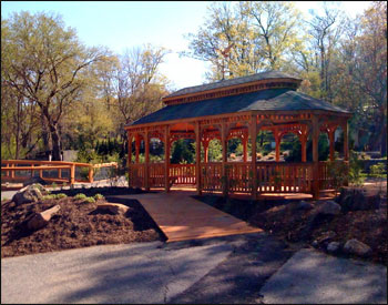 12x24 Red Cedar Oval Double Roof Gazebo shown with Weathered Wood Asphalt Shingles, 10 bench sections, and Heron Copper Weathervane.(which has since been discontinued, check out our other weathervanes)