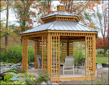 14 Custom Cedar Hexagon Double Roof Gazebo shown with Sandcastle Composite Deck, Custom Lattice Panels, Cupola, and Charcoal Metal Roof.