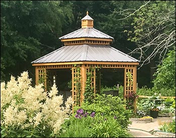 14 Custom Cedar Hexagon Double Roof Gazebo shown with Sandcastle Composite Deck, Custom Lattice Panels, Cupola, and Charcoal Metal Roof.