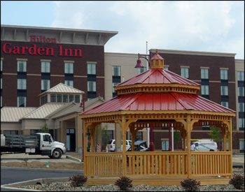 16 Treated Pine Octagon Double Roof Gazebo shown with treated pine deck, 1x3 standard railings, cupola, top railing sections, red metal roof, and clear stain sealer