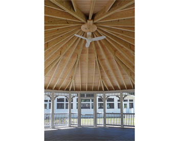 Interior of 30 Vinyl Dodecagon Gazebo shown with Gray composite deck, 1x1 railings, standard braces, no cupola, full set of screens and screen door, Old English Pewter asphalt shingles, Appliance White Avruc Outdoor Ceiling Fan w/ Light, screened floor, Hidden Wiring w/ 1 Receptacle & Switch, extra receptacle, additional door, straight posts, and top railing sections.