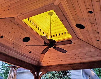 Optional Cedar Tongue and Groove Ceiling shown on a Double Roof Ramada with Custom Lighting, Ceiling Fan, and Stain